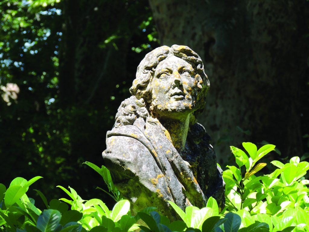 statue of molière in a garden